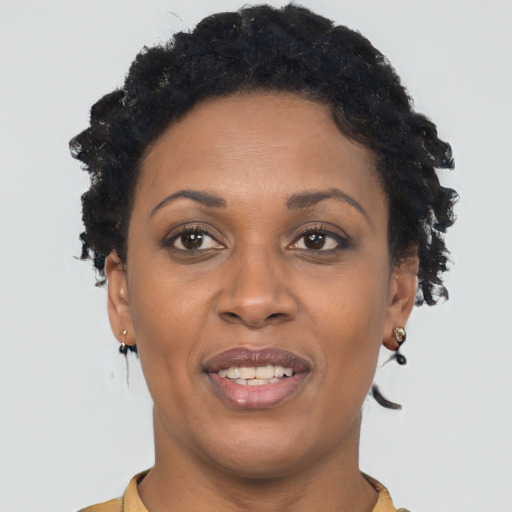 Joyful black adult female with short  brown hair and brown eyes