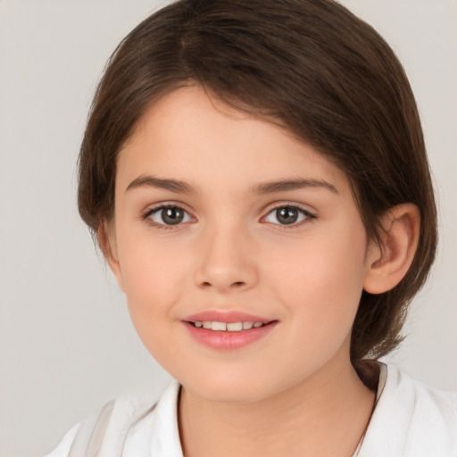 Joyful white child female with medium  brown hair and brown eyes