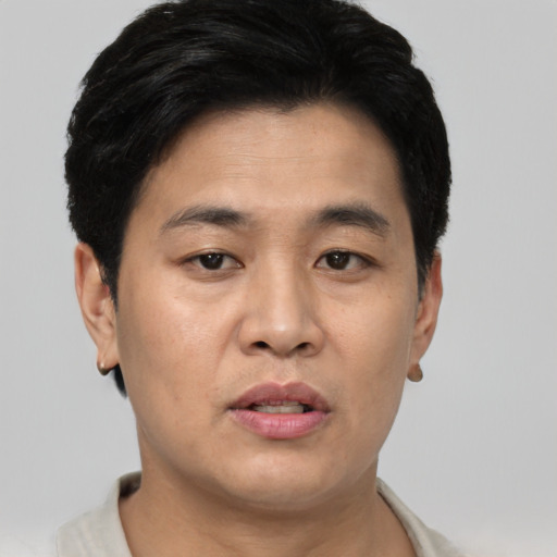 Joyful asian young-adult male with short  brown hair and brown eyes