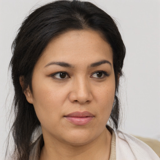 Joyful latino young-adult female with long  black hair and brown eyes