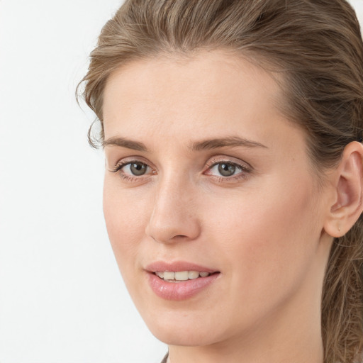 Joyful white young-adult female with long  brown hair and grey eyes