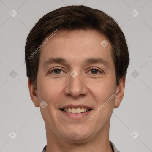 Joyful white adult male with short  brown hair and brown eyes