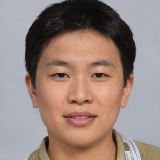 Joyful asian young-adult male with short  brown hair and brown eyes