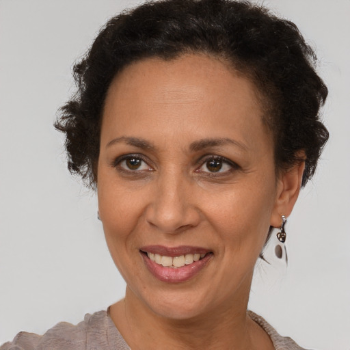 Joyful black adult female with short  brown hair and brown eyes