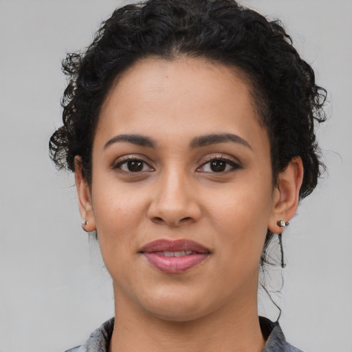 Joyful latino young-adult female with medium  black hair and brown eyes