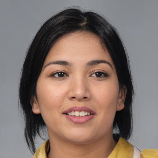 Joyful white young-adult female with medium  black hair and brown eyes