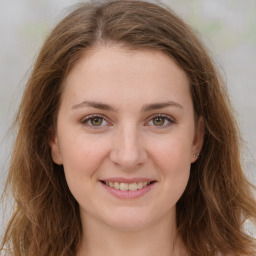 Joyful white young-adult female with long  brown hair and green eyes