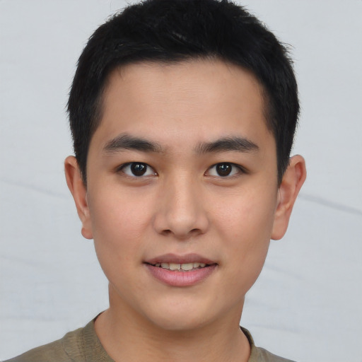 Joyful asian young-adult male with short  brown hair and brown eyes