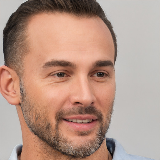 Joyful white adult male with short  brown hair and brown eyes