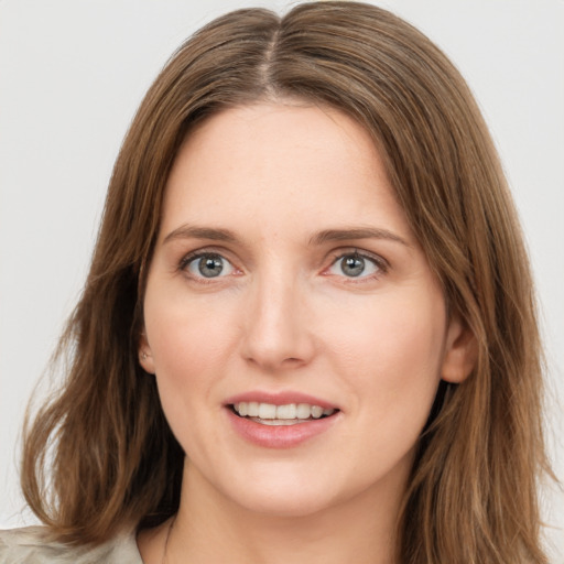 Joyful white young-adult female with medium  brown hair and green eyes