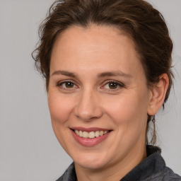 Joyful white adult female with medium  brown hair and brown eyes