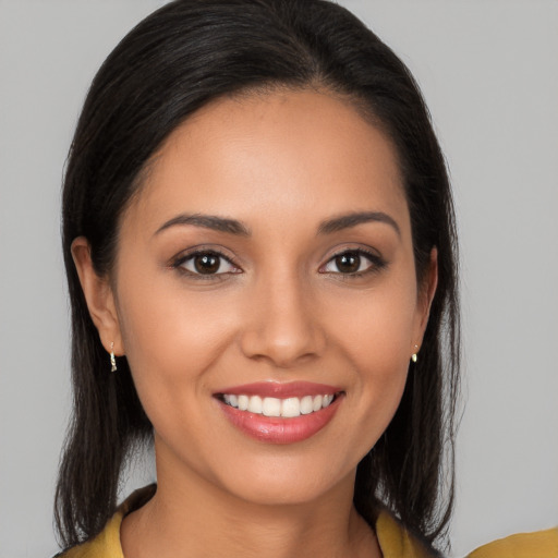 Joyful latino young-adult female with long  brown hair and brown eyes