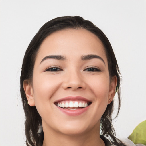 Joyful white young-adult female with long  black hair and brown eyes