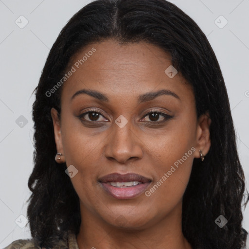 Joyful black young-adult female with long  brown hair and brown eyes