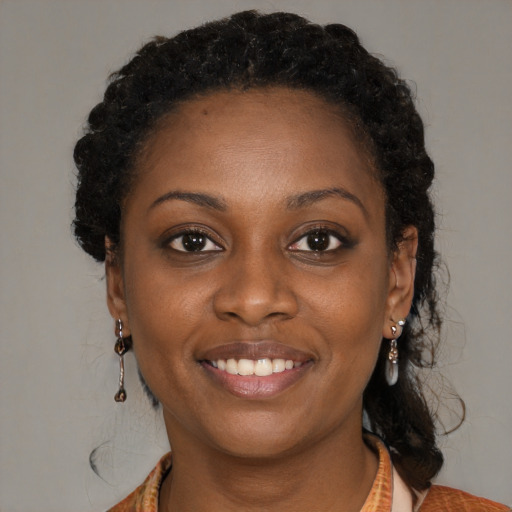 Joyful black young-adult female with medium  brown hair and brown eyes