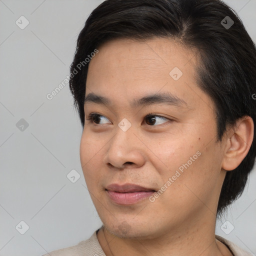 Joyful asian young-adult male with short  brown hair and brown eyes