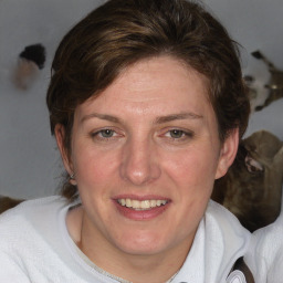 Joyful white adult female with medium  brown hair and blue eyes