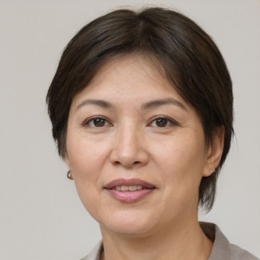 Joyful white adult female with short  brown hair and brown eyes