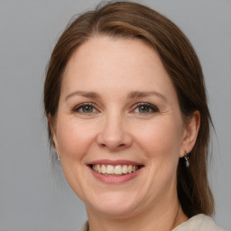 Joyful white adult female with medium  brown hair and blue eyes