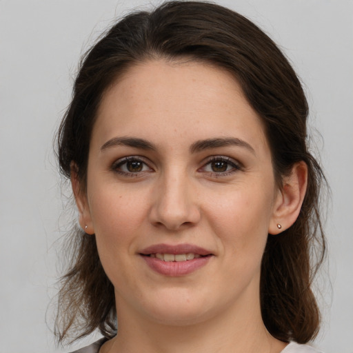 Joyful white young-adult female with medium  brown hair and brown eyes