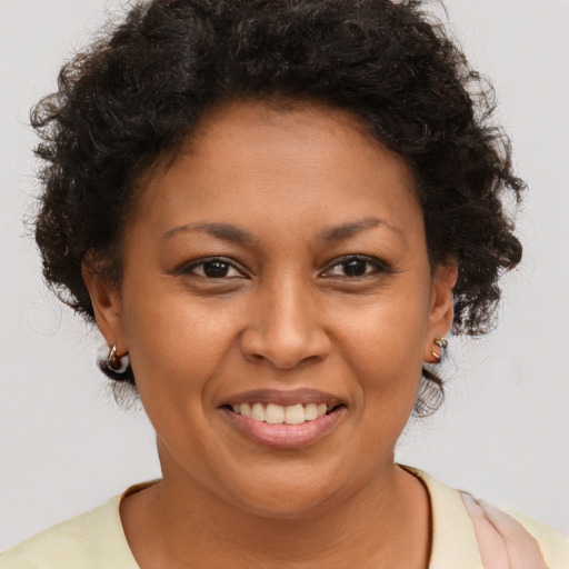 Joyful black young-adult female with short  brown hair and brown eyes