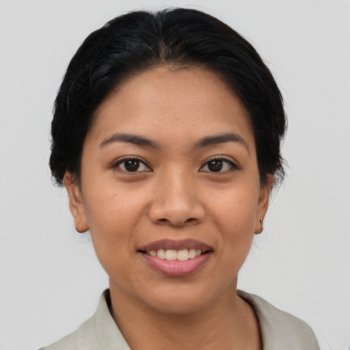 Joyful latino young-adult female with medium  brown hair and brown eyes