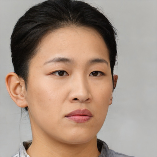 Neutral asian young-adult female with medium  brown hair and brown eyes