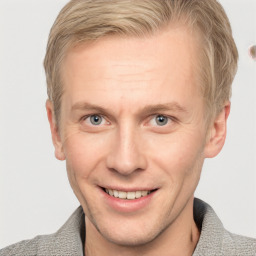 Joyful white adult male with short  brown hair and blue eyes