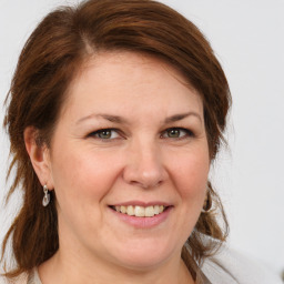 Joyful white adult female with medium  brown hair and grey eyes