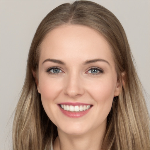 Joyful white young-adult female with long  brown hair and grey eyes