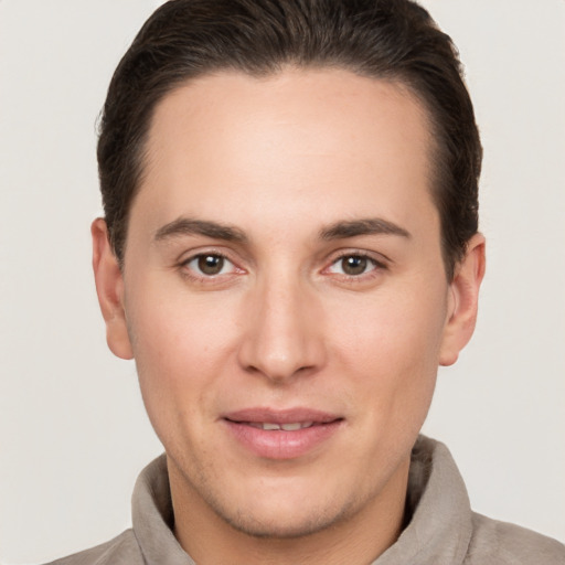 Joyful white young-adult male with short  brown hair and brown eyes