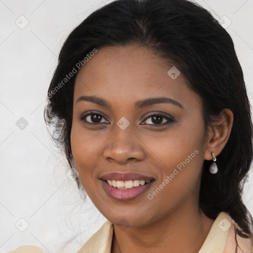 Joyful black young-adult female with long  brown hair and brown eyes