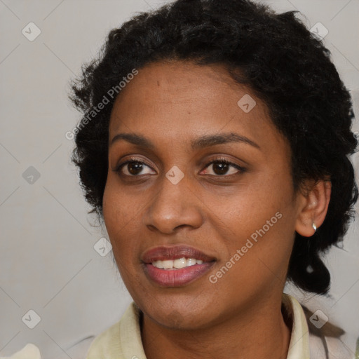 Joyful black adult female with medium  brown hair and brown eyes