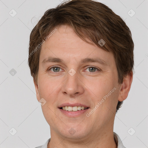 Joyful white adult male with short  brown hair and grey eyes