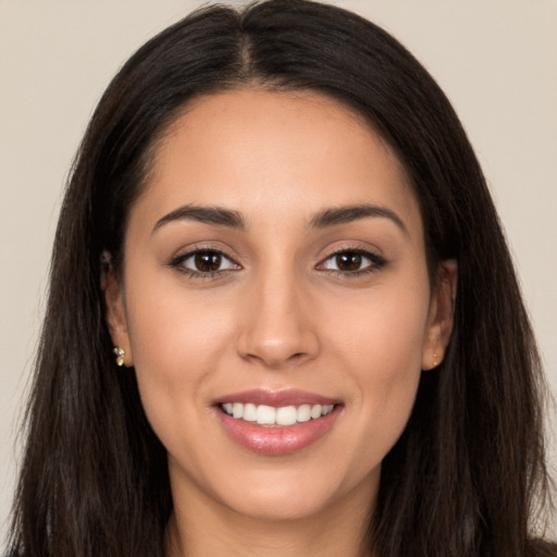 Joyful white young-adult female with long  brown hair and brown eyes