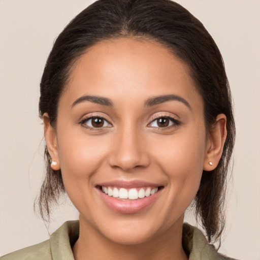 Joyful white young-adult female with medium  brown hair and brown eyes