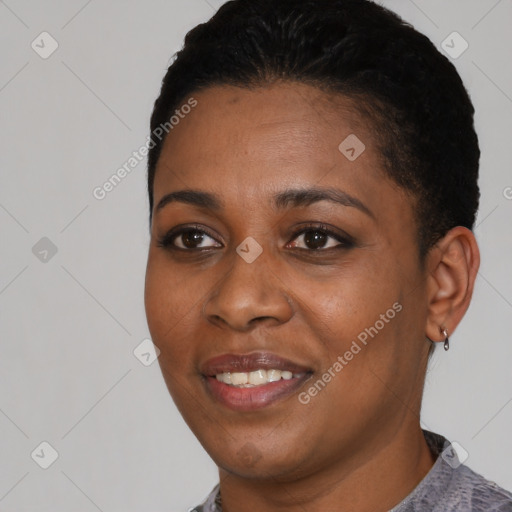 Joyful black young-adult female with short  black hair and brown eyes