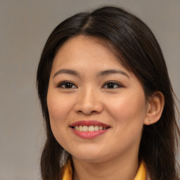 Joyful asian young-adult female with long  brown hair and brown eyes