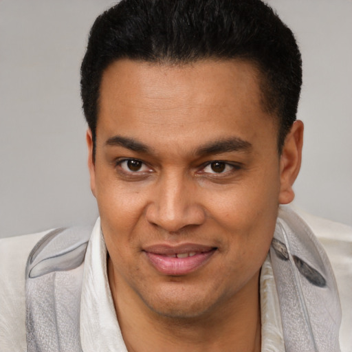 Joyful black young-adult male with short  brown hair and brown eyes