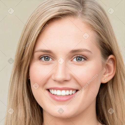 Joyful white young-adult female with long  brown hair and blue eyes