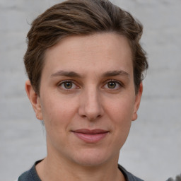 Joyful white young-adult female with short  brown hair and grey eyes