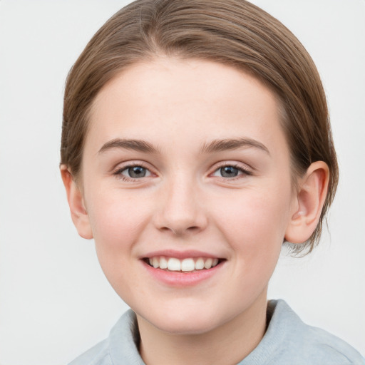 Joyful white child female with medium  brown hair and grey eyes