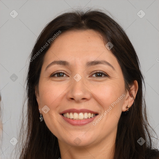 Joyful white adult female with long  brown hair and brown eyes