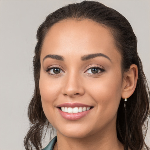 Joyful white young-adult female with long  brown hair and brown eyes