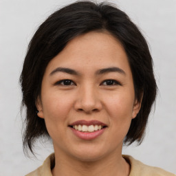 Joyful asian young-adult female with medium  brown hair and brown eyes