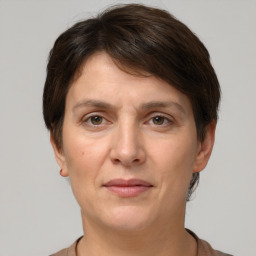 Joyful white adult female with short  brown hair and brown eyes