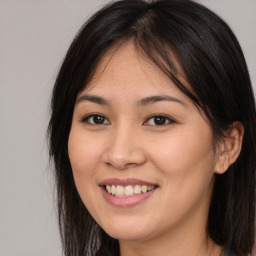 Joyful asian young-adult female with long  brown hair and brown eyes