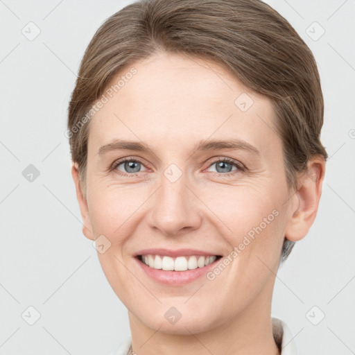 Joyful white young-adult female with short  brown hair and grey eyes