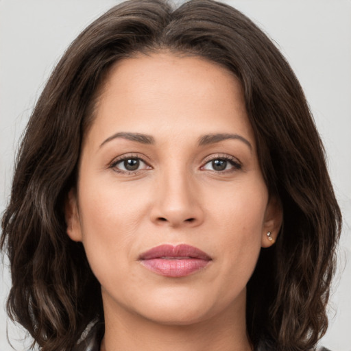 Joyful white young-adult female with long  brown hair and brown eyes