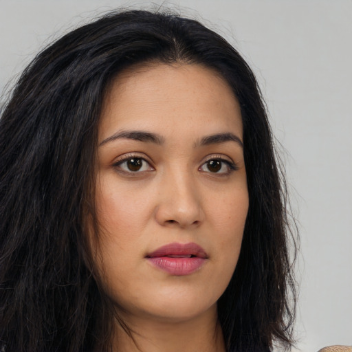 Joyful latino young-adult female with long  brown hair and brown eyes